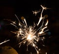 Bengal fire sparkles against the background of city lights, blurred bokeh. Royalty Free Stock Photo