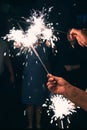 Bengal lights in the hands of people with sparks of fire on holiday Royalty Free Stock Photo