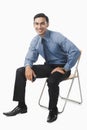 Bengali businessman sitting on a chair Royalty Free Stock Photo