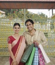 Bengali couple carrying shopping bags