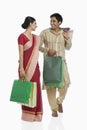 Bengali couple carrying shopping bags