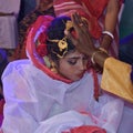 Bengali Indian Wedding - A Bengali Groom puts Sindoor vermilion to his bride, forehead. Bengali Marriage Ritual or ceremony.