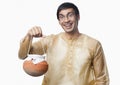 Bengali man carrying a pot of rasgulla