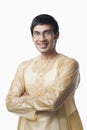 Bengali man standing with his arms crossed and smiling