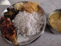 Bengali staple food of rice and fish served in a plate with other side dishes like lentils, boiled potato etc Royalty Free Stock Photo