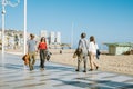Benidorm, Spain - April 01, 2023: People are walking along Levante beach seaside promenade. Benidorm - popular Spanish