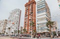 Tourists walking along the seafront of Levante beach in cloudy September weather