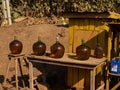 Primitive street gas station. Fuel in big bottles is standing on the table and chair