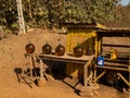 Primitive street gas station. Fuel in big bottles is standing on the table and chair