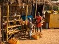 Primitive street gas station. Two boys selling the fuel from the bottles