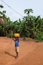 Benin, February 2020 - Local boy carrying water