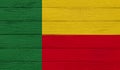 Benin flag on a wooden texture.