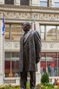 The Benito Juarez Statue along the Magnificent Mile with flags, office buildings and skyscrapers and lush green trees and plants