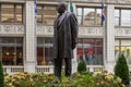 The Benito Juarez Statue along the Magnificent Mile with flags, office buildings and skyscrapers and lush green trees and plants