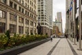 The Benito Juarez Statue along the Magnificent Mile with flags, office buildings and skyscrapers and lush green trees and plants