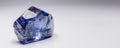 Benitoite is a rare precious natural stone on a white background. AI generated. Header banner mockup with space. Royalty Free Stock Photo