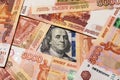 Benjamin Franklin on a hundred dollar bill surrounded by Russian rubles with a face value of five thousand each Royalty Free Stock Photo