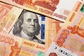 Benjamin Franklin on a hundred dollar bill surrounded by Russian rubles with a face value of five thousand each Royalty Free Stock Photo