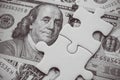 Benjamin Franklin president on US dollar banknote under unfinished white jigsaw puzzle. USA or world economy crisis situation Royalty Free Stock Photo