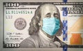 Benjamin Franklin With Worried and Concerned Expression Wearing Medical Face Mask On One Hundred Dollar Bill Royalty Free Stock Photo