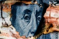 Benjamin Franklins face peeking out of a hole in a 5000 ruble banknote Royalty Free Stock Photo