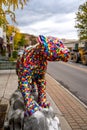 A vertical view of a rainbow mosaic covered Catamount Vermont Mountain Lion sculpture. This