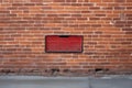 bent license plate on red brick wall background Royalty Free Stock Photo