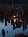 Bent man holding the old lamp outdoors near the lake. Hand holds a large lamp in the dark.  Ancient kerosene lantern illuminates Royalty Free Stock Photo