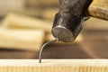 The bent nail sits on a hammer, a metalwork workshop Royalty Free Stock Photo