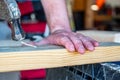 Bent nail into a wooden board with a hammer