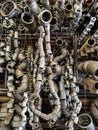 Bent pieces of rusted metal pipes hanging garland in a metal workshop Royalty Free Stock Photo