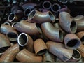 Bent pieces of rusted metal pipes in a metal workshop Royalty Free Stock Photo
