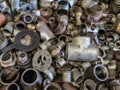 Bent pieces of rusted metal pipes and other metal parts in a metal workshop Royalty Free Stock Photo