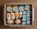 Bento box set of Sushi, California roll, Maki sushi roll. Japanese food in A Single portion takeout or take home meal in paper