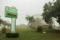 Placard on a garden and church in a foggy day