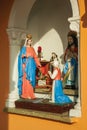 Statuettes of Virgin Mary and saints in a shrine