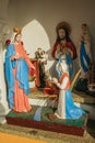 Statuettes of Virgin Mary and saints in a shrine