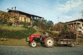 Tractor on a road and wood house with garden Royalty Free Stock Photo