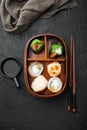 Bento Lunch Sushi roll, on black stone background, top view flat lay