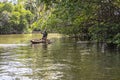 BENTOTA, SRI LANKA - 14 NOVEMBER, 2019: A local resident with a monkey on a boat on the Bentota Ganga river in the jungle