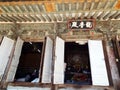 Entrance doors of one of the Beomeosa temples with worshipers praying inside. Busan, Korea