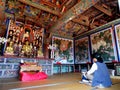 A woman praying in one of the colorful Buddhist temples in Beomeosa. Busan, Korea