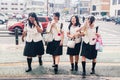 Four Japanese Schoolgirls crossing the street.Heat in the city Royalty Free Stock Photo