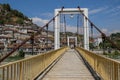 A pedestrian bridge over the river Lumi i Osumit overlooking the medieval white houses - Unesco heritage