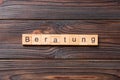 Beratung word written on wood block. Beratung text on cement table for your desing, concept