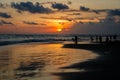 Berawa beach Pantai Berawa at sunset. Silhouettes of two people sitting in the tide. Canggu, Bali, Indonesia. Royalty Free Stock Photo