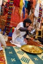 Berber man pouring tea in a carpet shop