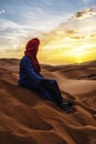 Berber man at sunset in the Sahara desert of Merzouga, Morocco Royalty Free Stock Photo