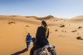 Berber nomad and a girl on camel in Sahara desert