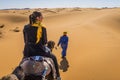 Berber nomad and a girl on camel in Sahara desert